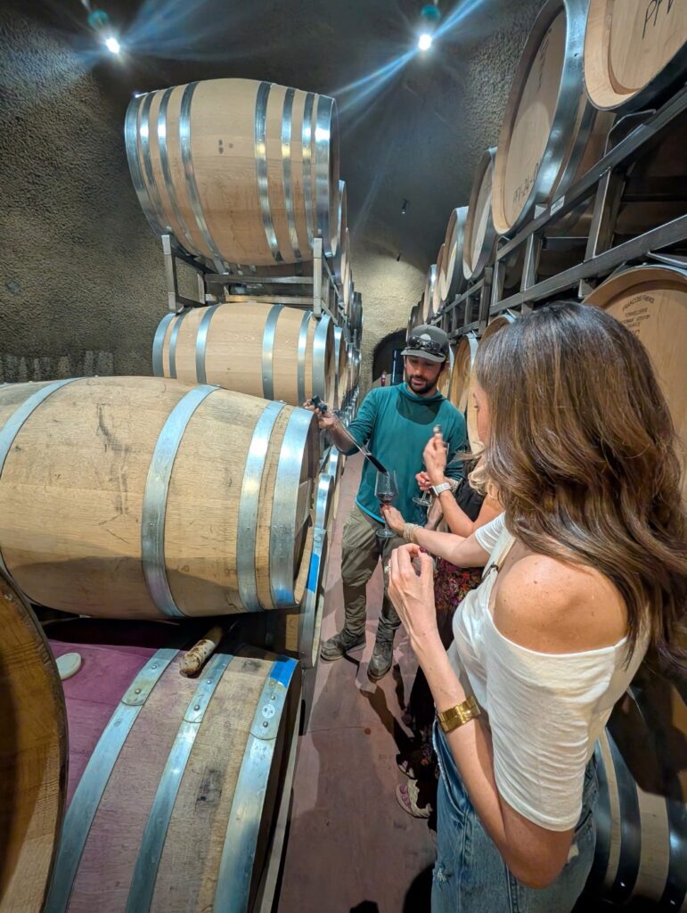Greg the winemaker doing barrel samples in the barrel room at VINCENT VINES