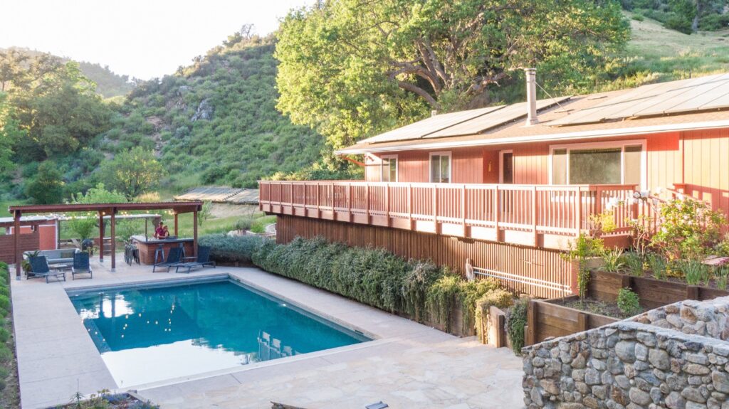 Hero shot of Vineyard Chateau house overlooking the pool at sunset