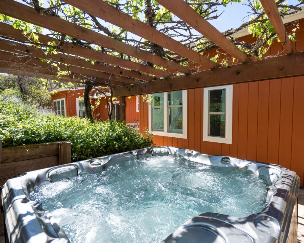 Hot tub under grape arbor at Vineyard Chateau, Carmel Valley