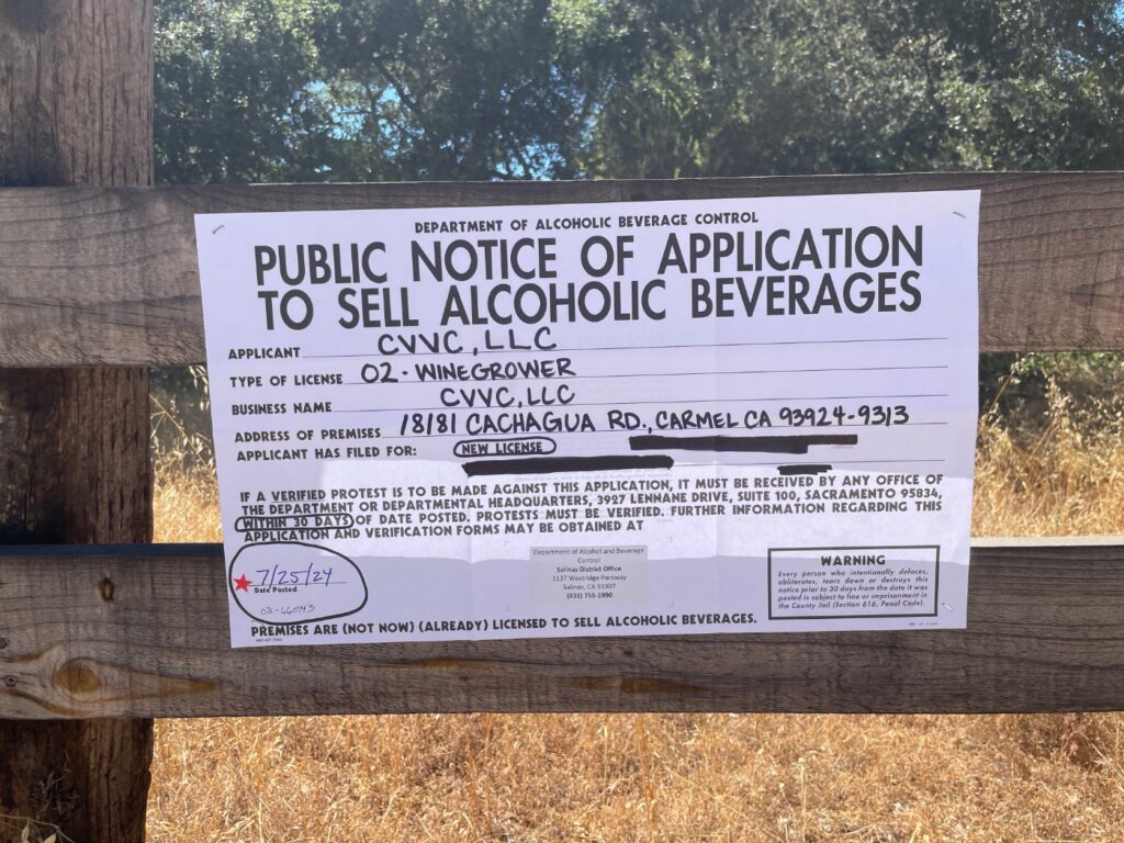 Public notice of application to sell alcoholic beverages posted on the fence in front of winery