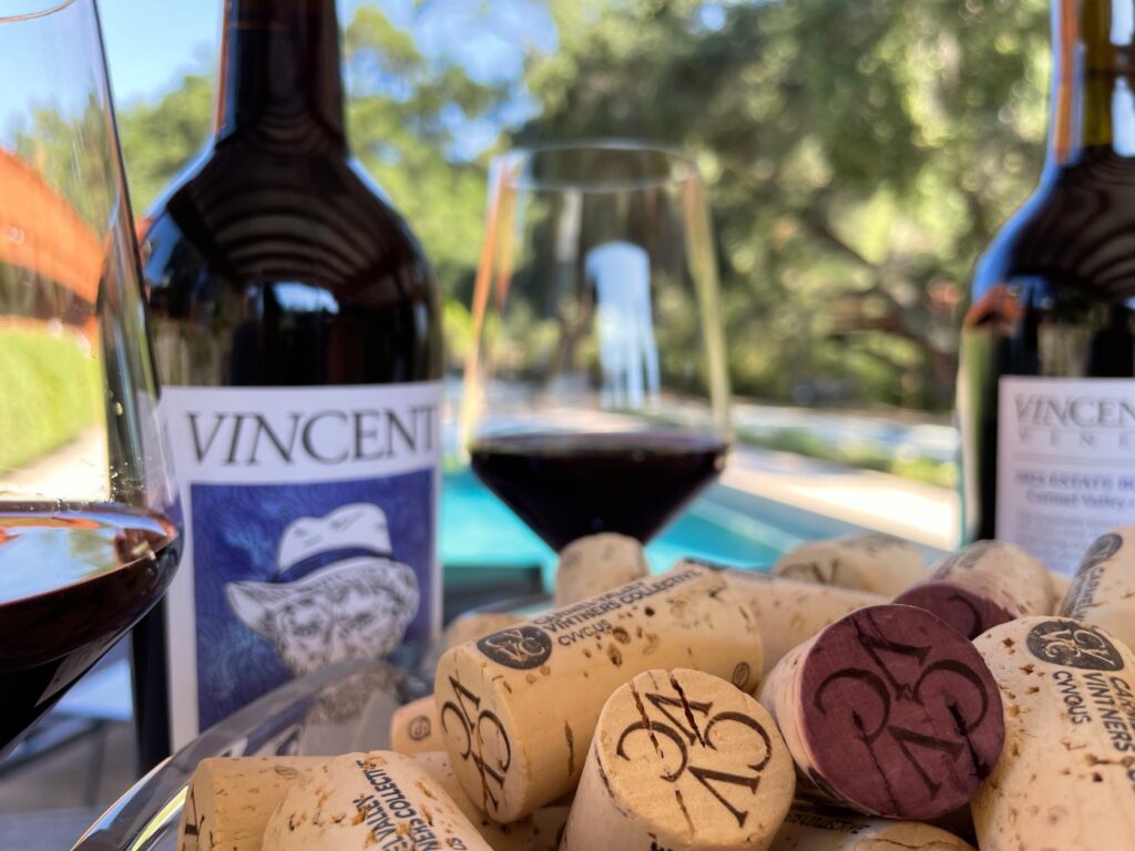 VINCENT VINES Estate Merlot bottle and glass with cork by the pool at Vineyard Chateau