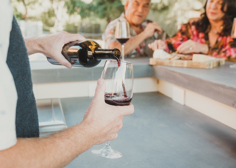 Guests enjoying a wine and charcuterie experience at the outdoor bar