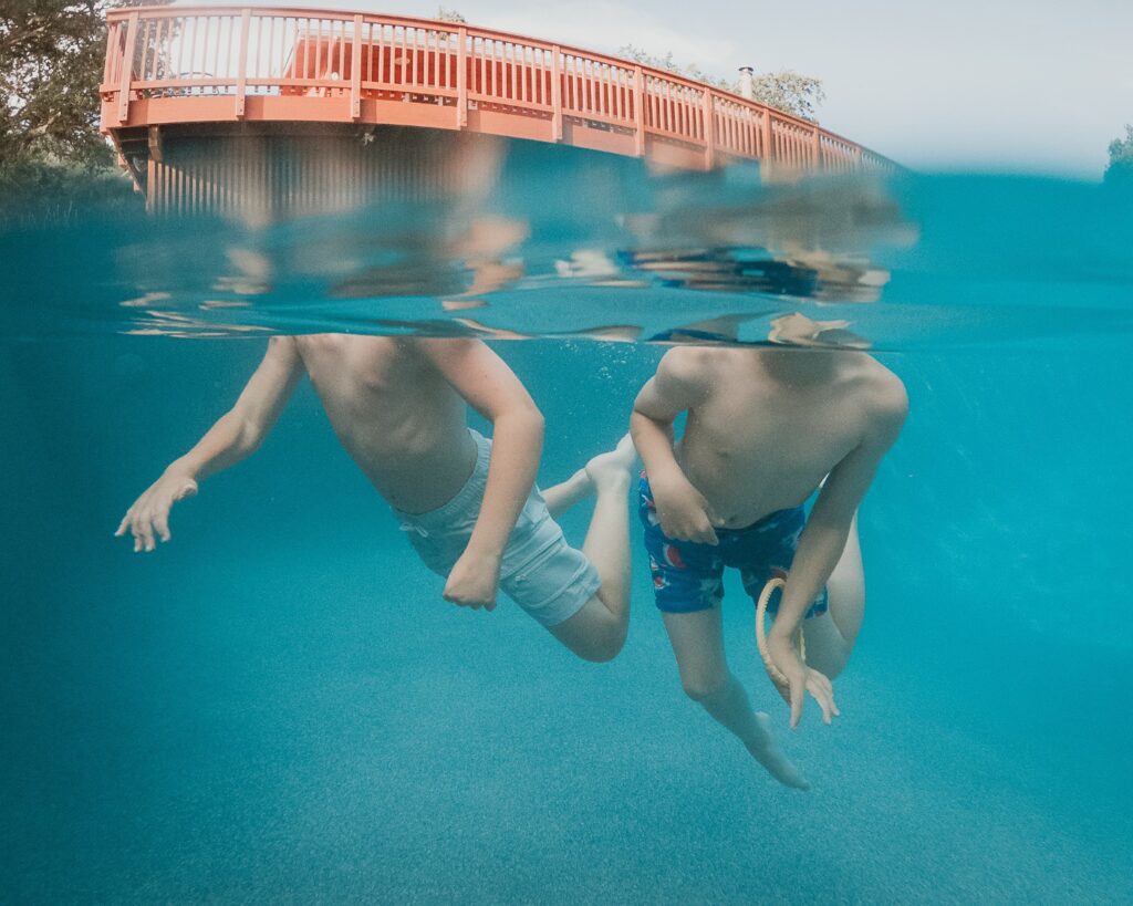 Kids underwater in the saltwater pool at Vineyard Chateau