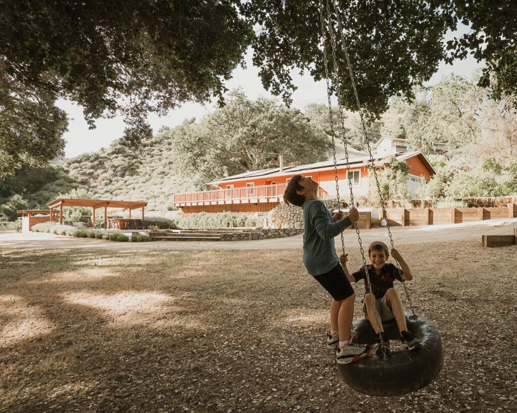 Kids on the tire swing in front of Vineyard Chateau